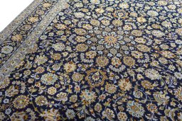 Backside of handmade 2000s Kashan rug showing knot structure and weave density