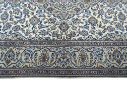 Corner detail of 2000s Kashan rug showing border pattern and Wool pile