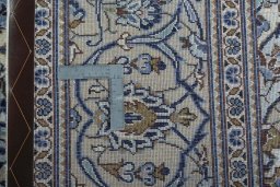 Backside of handmade 2000s Kashan rug showing knot structure and weave density