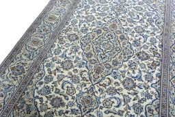Backside of handmade 2000s Kashan rug showing knot structure and weave density