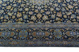 Corner detail of 2000s Kashan rug showing border pattern and Wool pile
