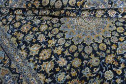 Close-up detail of 2000s Kashan rug from Iran / Persia showing Wool weave