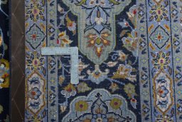 Backside of handmade 2000s Kashan rug showing knot structure and weave density