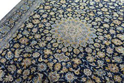 Backside of handmade 2000s Kashan rug showing knot structure and weave density