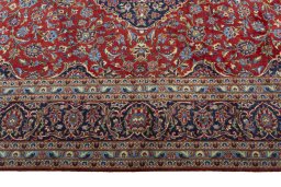Corner detail of 2000s Kashan rug showing border pattern and Cork pile