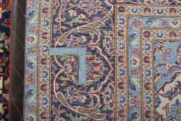Backside of handmade 2000s Kashan rug showing knot structure and weave density