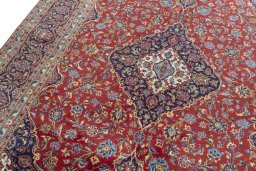 Backside of handmade 2000s Kashan rug showing knot structure and weave density