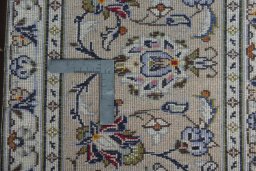 Backside of handmade 2000s Kashan rug showing knot structure and weave density