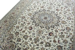 Backside of handmade 2000s Kashan rug showing knot structure and weave density