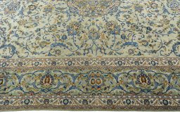 Corner detail of 2000s Kashan rug showing border pattern and Wool pile