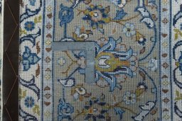 Backside of handmade 2000s Kashan rug showing knot structure and weave density