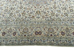 Corner detail of 2000s Kashan rug showing border pattern and Cork pile