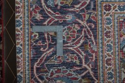 Backside of handmade 2000s Kashan rug showing knot structure and weave density