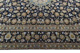 Corner detail of 2000s Kashan rug showing border pattern and Wool pile