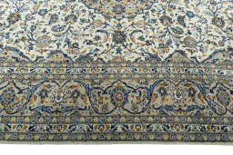 Corner detail of 2000s Kashan rug showing border pattern and Wool pile
