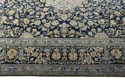 Corner detail of 2000s Kashan rug showing border pattern and Wool pile