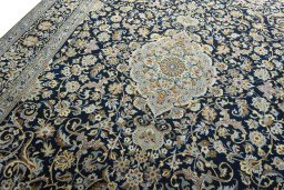 Backside of handmade 2000s Kashan rug showing knot structure and weave density