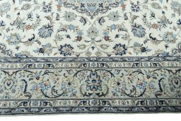Corner detail of 2000s Kashan rug showing border pattern and Wool pile