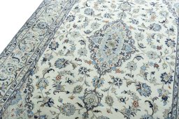 Backside of handmade 2000s Kashan rug showing knot structure and weave density
