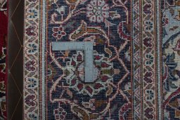 Backside of handmade 2000s Kashan rug showing knot structure and weave density