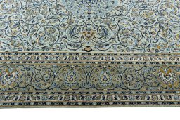 Corner detail of 2000s Kashan rug showing border pattern and Wool pile