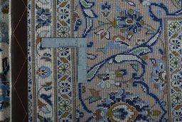 Backside of handmade 2000s Kashan rug showing knot structure and weave density
