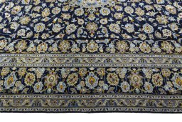 Corner detail of 2000s Kashan rug showing border pattern and Wool pile