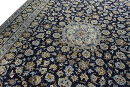 Backside of handmade 2000s Kashan rug showing knot structure and weave density