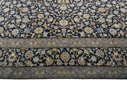 Corner detail of 2000s Kashan rug showing border pattern and Wool pile
