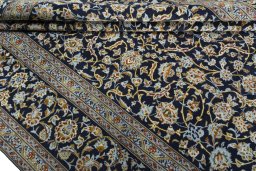 Close-up detail of 2000s Kashan rug from Iran / Persia showing Wool weave