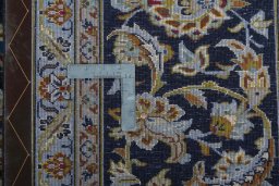 Backside of handmade 2000s Kashan rug showing knot structure and weave density