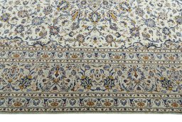 Corner detail of 2000s Kashan rug showing border pattern and Wool pile