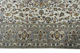 Corner detail of 2000s Kashan rug showing border pattern and Wool pile