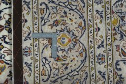 Backside of handmade 2000s Kashan rug showing knot structure and weave density