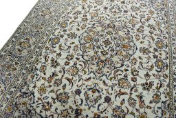 Backside of handmade 2000s Kashan rug showing knot structure and weave density