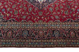 Corner detail of 2000s Kashan rug showing border pattern and Wool pile