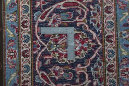 Backside of handmade 2000s Kashan rug showing knot structure and weave density