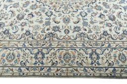Corner detail of 2000s Kashan rug showing border pattern and Wool pile