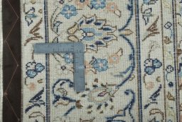 Backside of handmade 2000s Kashan rug showing knot structure and weave density