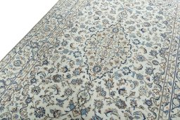 Backside of handmade 2000s Kashan rug showing knot structure and weave density