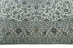 Corner detail of 2000s Kashan rug showing border pattern and Wool pile