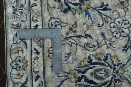 Backside of handmade 2000s Kashan rug showing knot structure and weave density