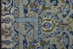 Backside of handmade 2000s Kashan rug showing knot structure and weave density