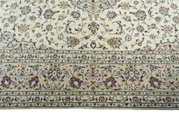 Corner detail of 2000s Kashan rug showing border pattern and Wool pile
