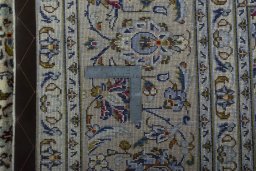 Backside of handmade 2000s Kashan rug showing knot structure and weave density