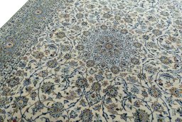 Backside of handmade 2000s Kashan rug showing knot structure and weave density