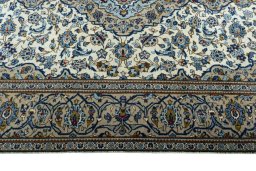 Corner detail of 2000s Kashan rug showing border pattern and Wool pile