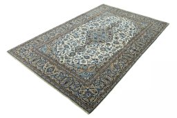 Corner detail of 2000s Kashan rug showing border pattern and Wool pile