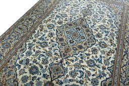 Backside of handmade 2000s Kashan rug showing knot structure and weave density