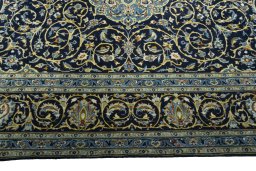 Corner detail of 2000s Kashan rug showing border pattern and Wool pile